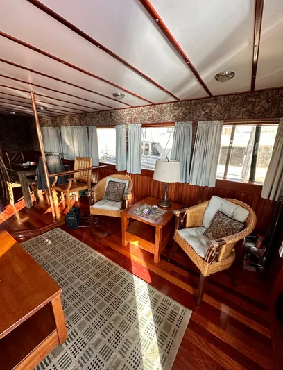 Boatel I Yacht Photos Pics Interior of a 1998 Custom 65 Foot Trawler with wooden furnishings and natural light.