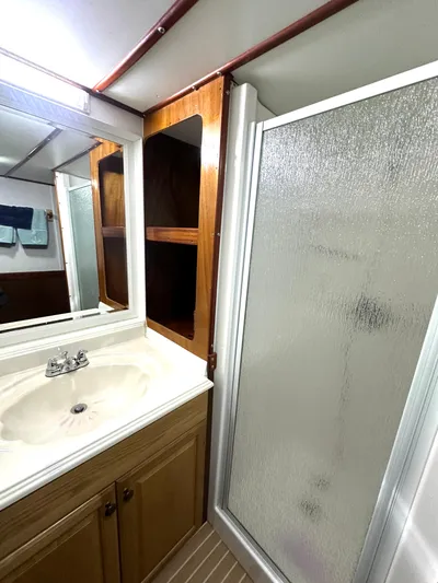 Boatel I Yacht Photos Pics Bathroom interior of a 1998 Custom 65 Foot Trawler with shower and vanity.