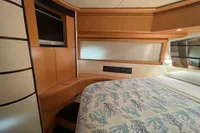 Luxurious cabin interior of a 2005 Pershing 76 yacht with modern wood finishes.