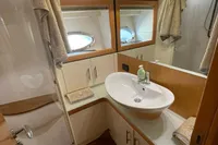 Luxurious bathroom in 2005 Pershing 76 yacht with modern fixtures and elegant design.