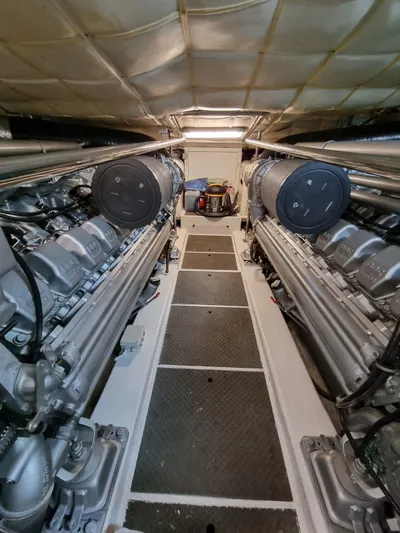  Yacht Photos Pics Engine room of a 2005 Pershing 76 yacht, showcasing dual engines and mechanical components.