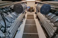 Engine room of a 2005 Pershing 76 yacht, showcasing dual engines and mechanical components.