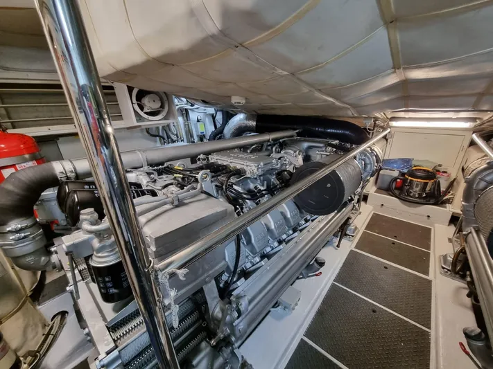  Yacht Photos Pics Engine room of a 2005 Pershing 76 yacht, showcasing mechanical components and equipment.