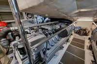 Engine room of a 2005 Pershing 76 yacht, showcasing mechanical components and equipment.