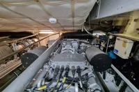 Engine room of a 2005 Pershing 76 yacht, showcasing mechanical components and systems.