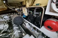 Engine room of a 2005 Pershing 76 yacht, showcasing mechanical components and systems.