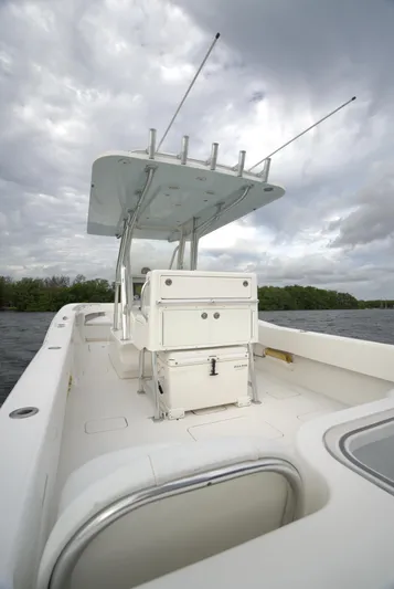  Yacht Photos Pics Invincible 33 boat, 2012 model, with center console and rod holders on a cloudy day.