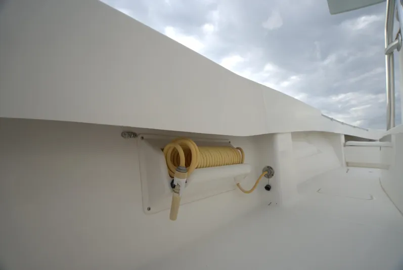  Yacht Photos Pics Invincible 33 boat deck with coiled yellow hose, 2012 model.