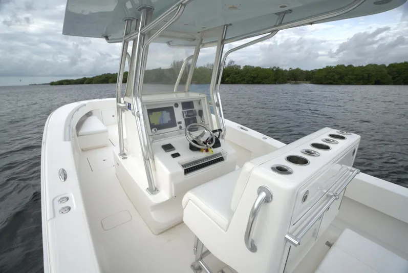  Yacht Photos Pics Invincible 33 boat, 2012 model, featuring a sleek console and seating on calm waters.