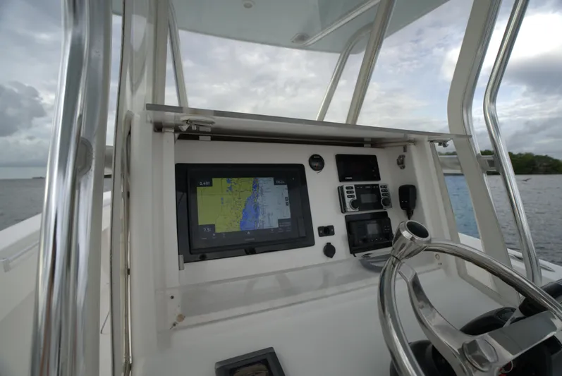  Yacht Photos Pics Invincible 33 boat dashboard with navigation system, steering wheel, and controls, 2012 model.