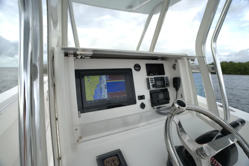  Yacht Photos Pics Invincible 33 boat dashboard with navigation system, steering wheel, and controls, 2012 model.