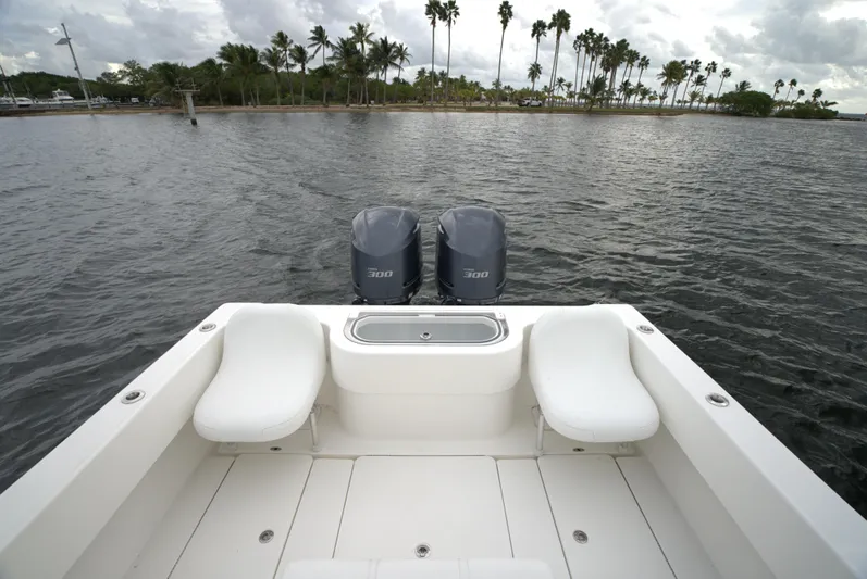  Yacht Photos Pics Invincible 33 boat, 2012 model, with dual engines on a calm water backdrop.