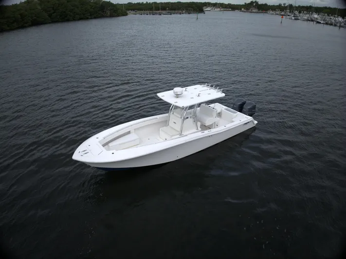  Yacht Photos Pics 2012 Invincible 33 boat on calm water, featuring a sleek white design.