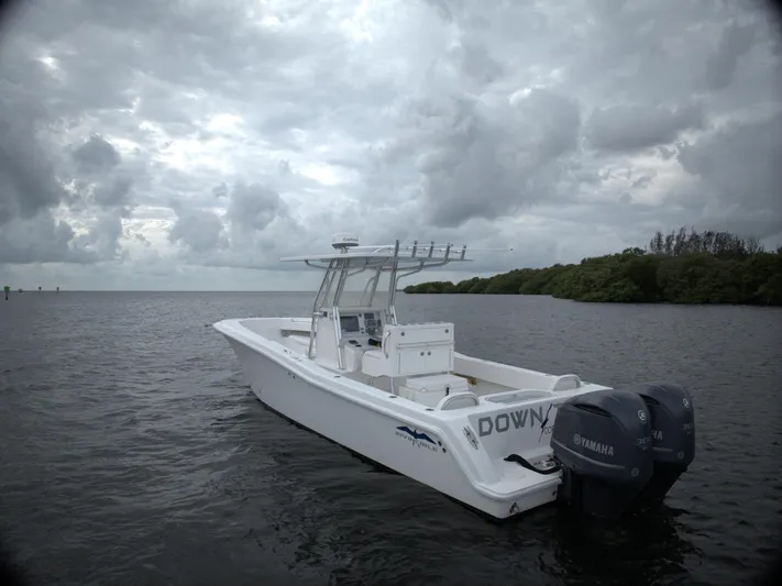  Yacht Photos Pics White 2012 Invincible 33 boat with Yamaha engines on a cloudy day.
