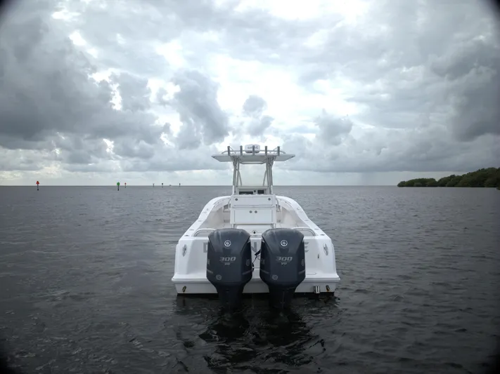  Yacht Photos Pics Invincible 33 boat on water, cloudy sky, dual engines, 2012 model.