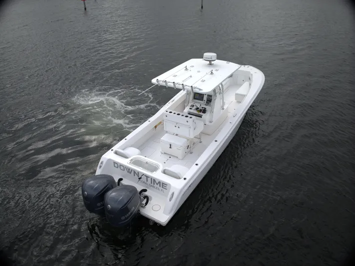  Yacht Photos Pics Invincible 33 boat, 2012 model, on water with dual outboard motors.