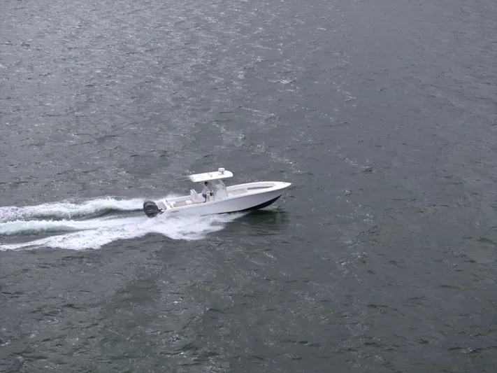  Yacht Photos Pics Invincible 33 boat cruising on open water, 2012 model.