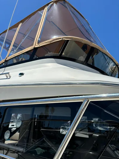  Yacht Photos Pics 2014 Carver C34 yacht with sleek design and tinted windows under clear blue sky.
