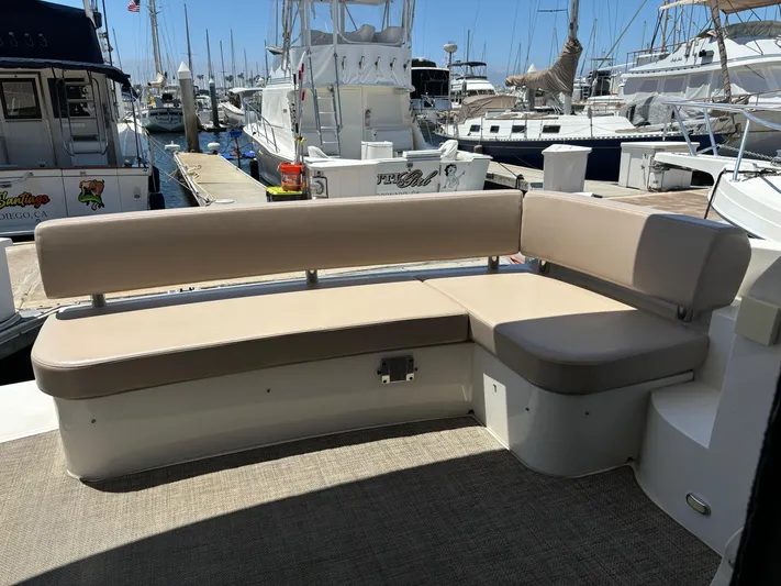  Yacht Photos Pics 2014 Carver C34 yacht seating area at marina, surrounded by boats.