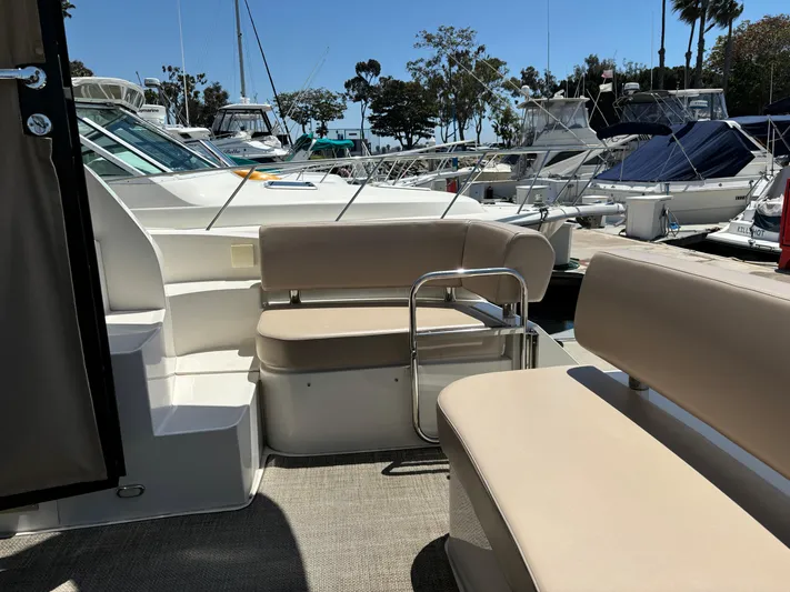  Yacht Photos Pics 2014 Carver C34 yacht interior with beige seating, docked at a marina.