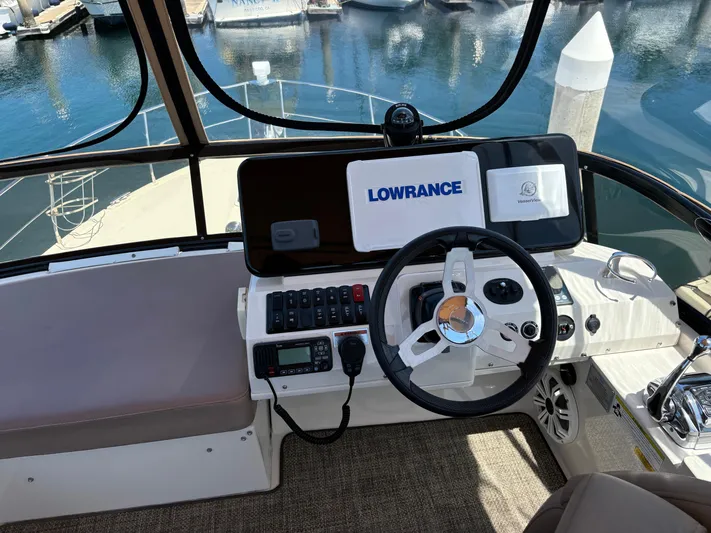  Yacht Photos Pics Helm of 2014 Carver C34 yacht with Lowrance navigation system, docked at marina.
