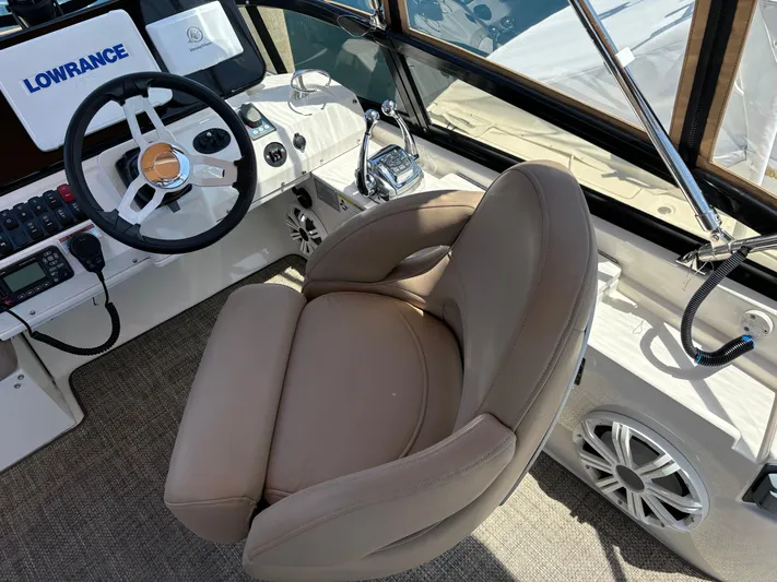  Yacht Photos Pics Helm of 2014 Carver C34 boat with steering wheel and captain's chair.