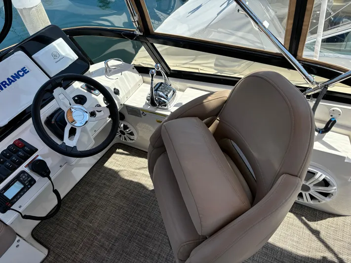  Yacht Photos Pics Interior of 2014 Carver C34 boat with steering wheel and beige captain's chair.