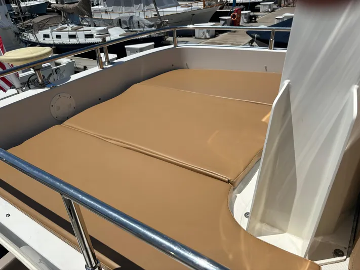  Yacht Photos Pics 2014 Carver C34 yacht with tan sunbathing deck, docked at marina.