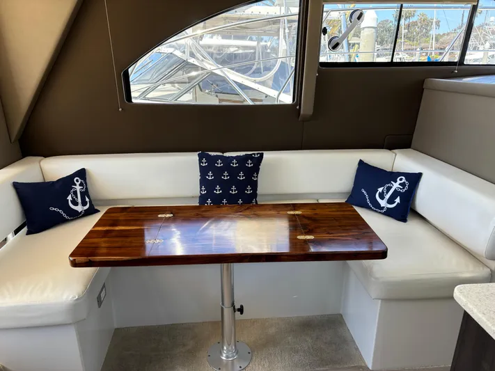  Yacht Photos Pics Interior of 2014 Carver C34 yacht with white seating and anchor-themed cushions.