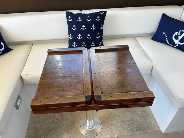  Yacht Photos Pics Wooden table on Carver C34 yacht with nautical-themed cushions, 2014 model.