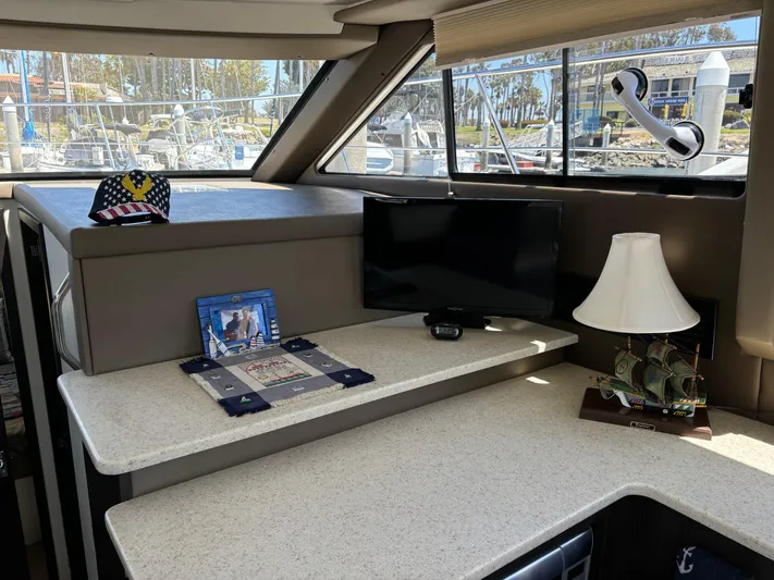  Yacht Photos Pics Interior of 2014 Carver C34 yacht with TV, lamp, and decorative items.