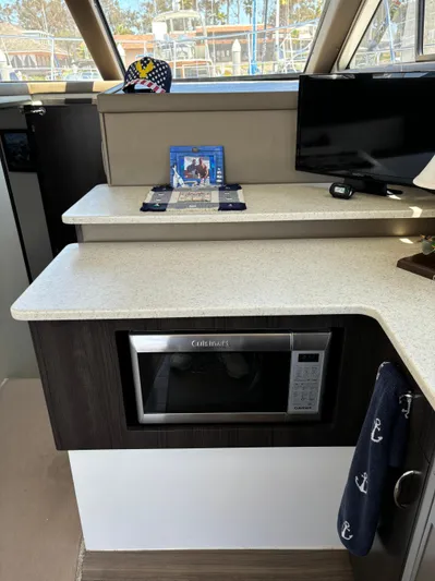  Yacht Photos Pics Interior of 2014 Carver C34 yacht with microwave, TV, and countertop.