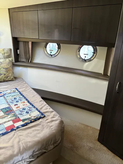  Yacht Photos Pics Interior of 2014 Carver C34 yacht with bed, cabinets, and porthole windows.