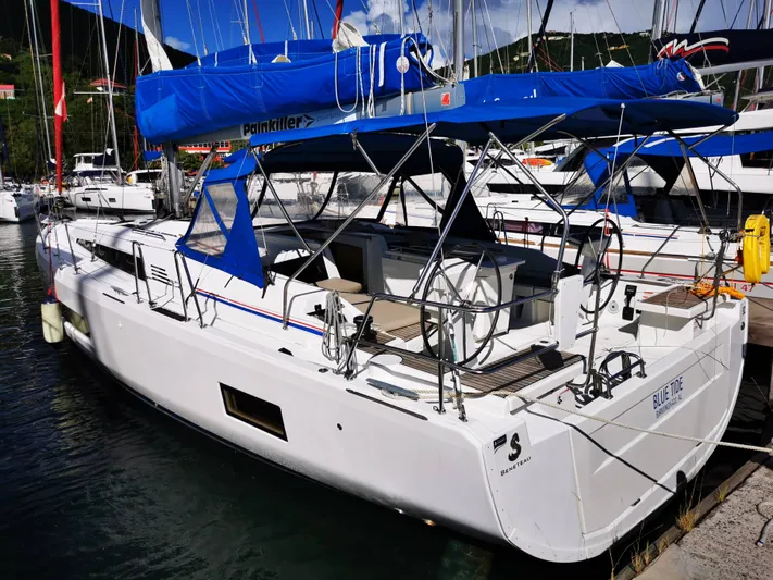 Blue Tide Yacht Photos Pics 2020 Beneteau Oceanis 46.1 sailboat docked in marina, featuring blue sail cover.