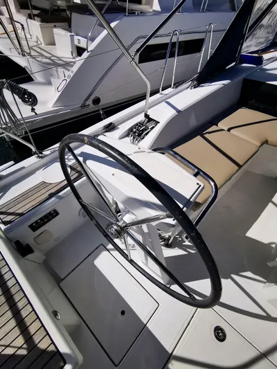 Blue Tide Yacht Photos Pics 2020 Beneteau Oceanis 46.1 yacht cockpit with steering wheel and seating area.