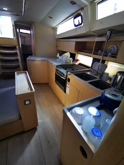 Blue Tide Yacht Photos Pics Interior of 2020 Beneteau Oceanis 46.1 yacht kitchen with modern amenities and wooden finish.