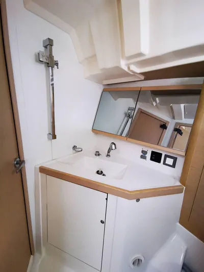 Blue Tide Yacht Photos Pics Beneteau Oceanis 46.1 2020 bathroom with modern sink, mirror, and shower fixtures.