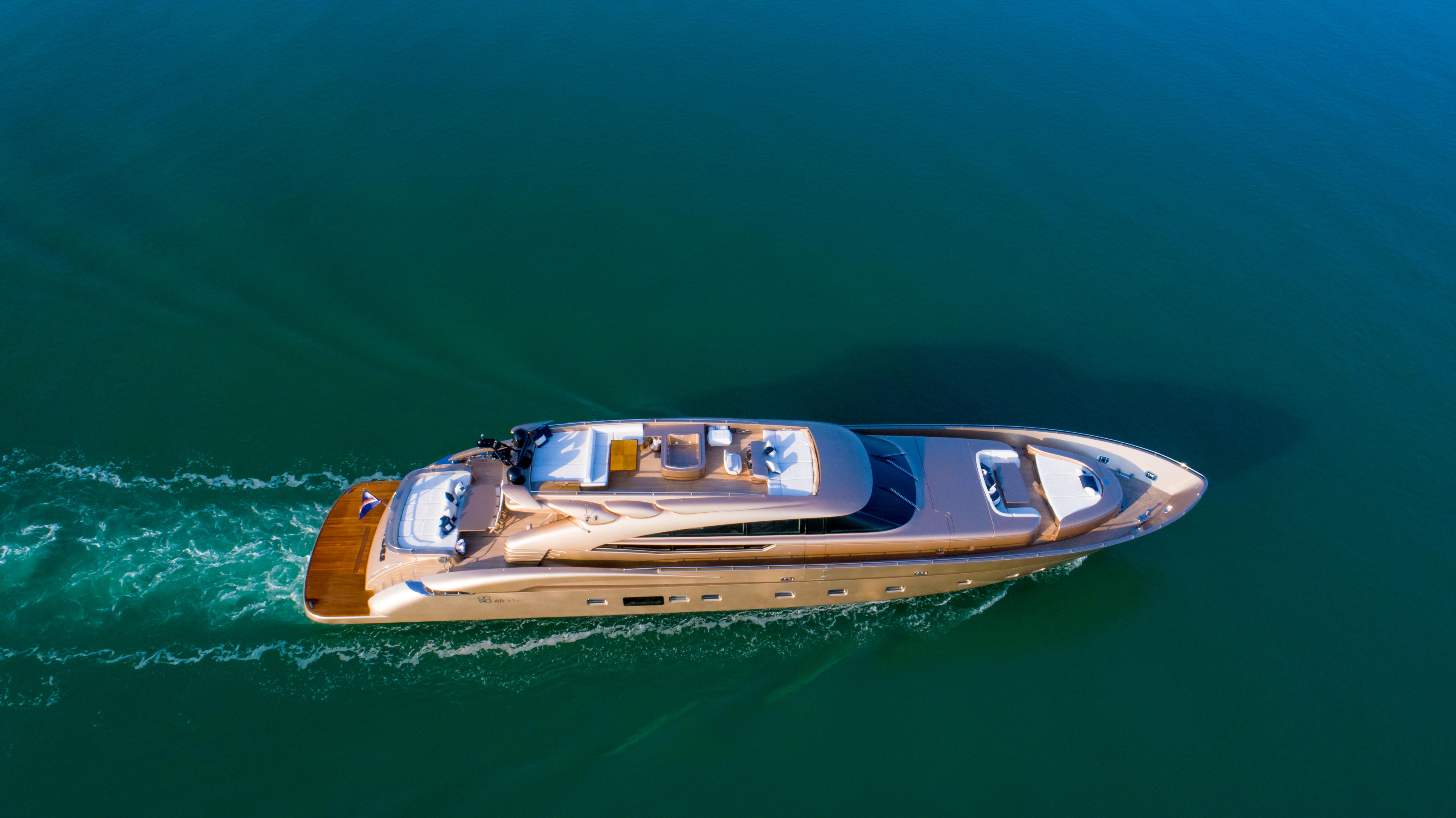 Aerial view of 2010 AB 118 luxury yacht cruising on calm waters.