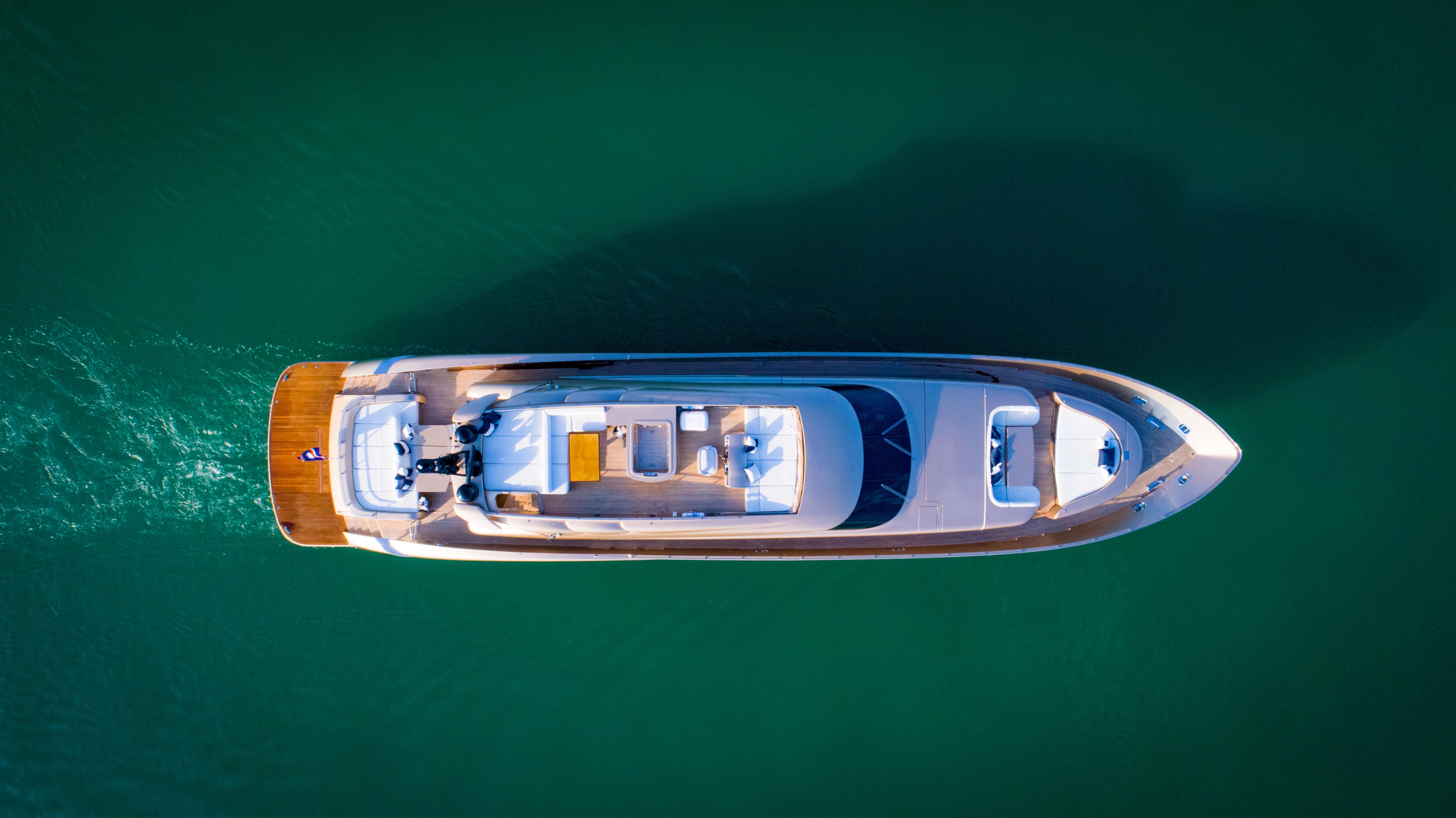 Aerial view of 2010 AB 118 luxury yacht cruising on calm green waters.