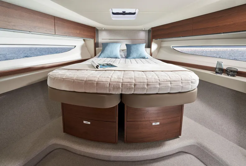 50 Princess V50 2026 Yacht Photos Pics Luxurious 2026 Princess V50 Deck Salon yacht bedroom with elegant wood finishes and ocean view.