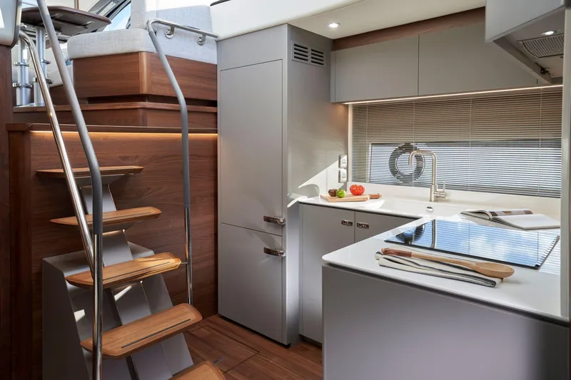 50 Princess V50 2026 Yacht Photos Pics Modern kitchen interior of 2026 Princess V50 Deck Salon yacht, featuring sleek design and wooden accents.