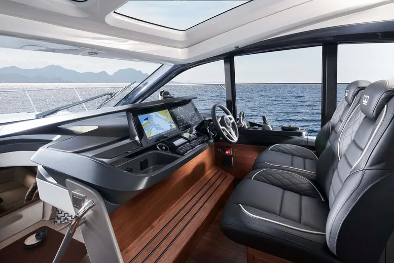 50 Princess V50 2026 Yacht Photos Pics Luxurious 2026 Princess V50 Deck Salon interior with modern navigation system and leather seating.