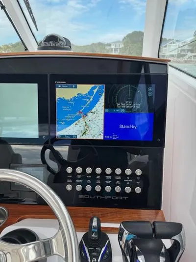  Yacht Photos Pics 2023 Southport 33 DC boat dashboard with navigation screens and controls.