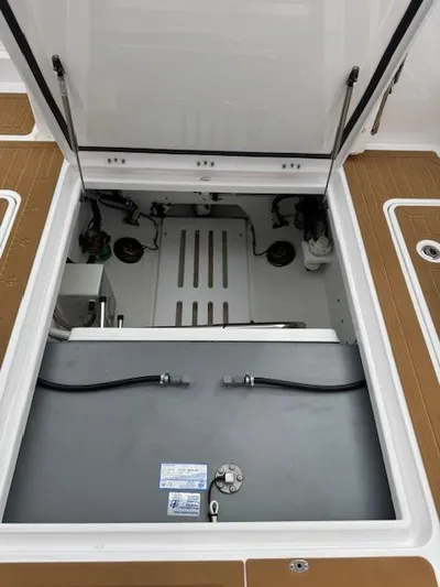  Yacht Photos Pics 2023 Southport 33 DC boat storage compartment with open hatch, showcasing interior details.