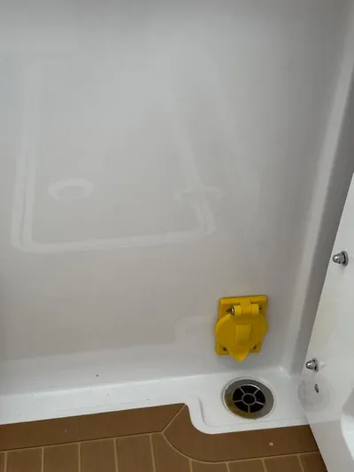  Yacht Photos Pics 2023 Southport 33 DC boat interior with yellow fixture and drain.