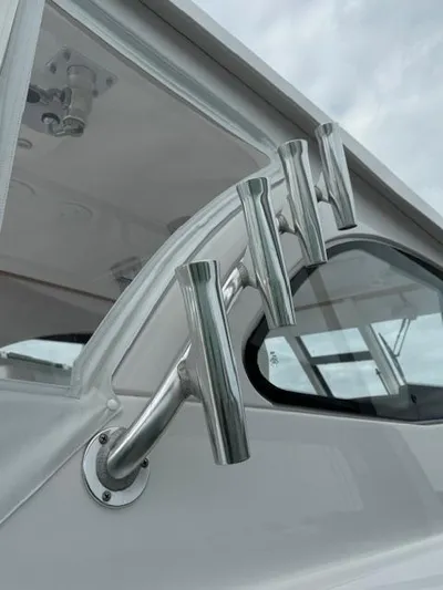  Yacht Photos Pics 2023 Southport 33 DC boat with sleek metal rod holders and modern design.