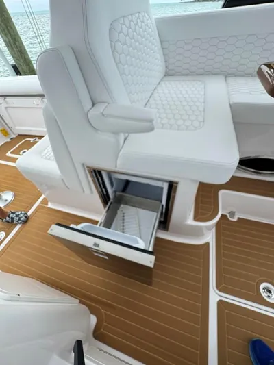  Yacht Photos Pics 2023 Southport 33 DC boat interior with white seating and open storage compartment.