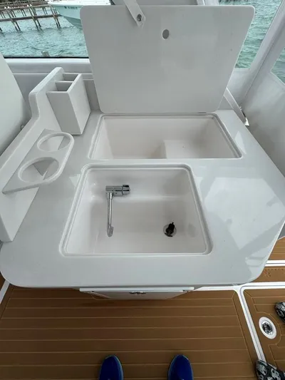  Yacht Photos Pics 2023 Southport 33 DC boat sink and storage area with ocean view.