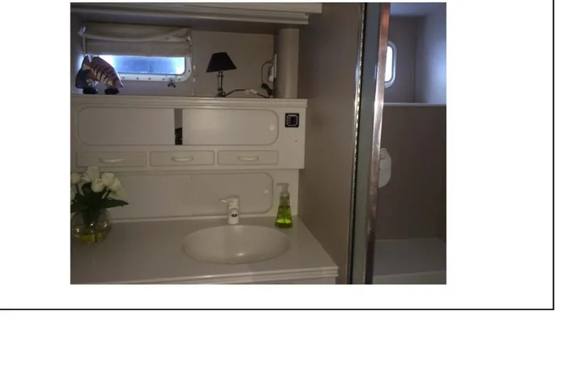 "focus" Yacht Photos Pics 1977 Hatteras 58 Yacht Fisherman bathroom with sink, mirror, and shower.