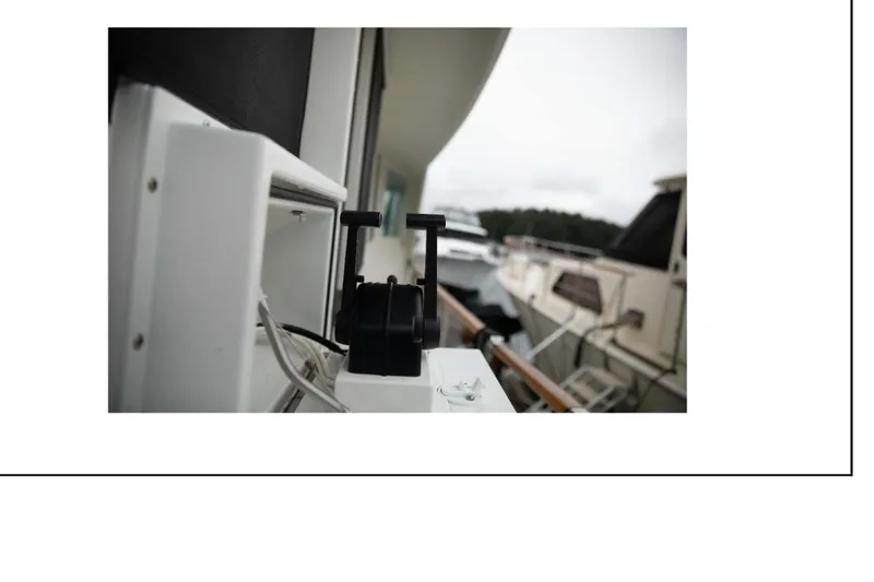 "focus" Yacht Photos Pics Close-up of a 1977 Hatteras 58 Yacht Fisherman deck equipment with boats in the background.